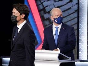 FILE: Liberal leader Justin Trudeau and Conservative Party leader Erin O'Toole leave the room following the federal election French-language leaders debate, in Gatineau, Quebec, Canada September 8, 2021.