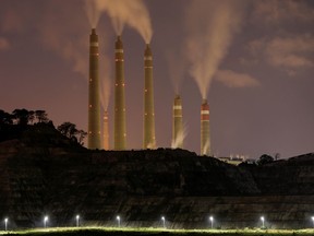 A dystopian scene of a coal-fired power plant. Civilization isn't fixing contemporary problems such as climate change; it's just coasting along on the coat-tails of other generations' achievements, says a new book from Andrew Potter.