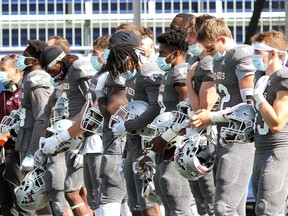 Ottawa Gee-Gees stand during a moment of silence on Saturday during a ceremony for Ottawa Gee-Gees defensive lineman Francis Perron who died after The Gee-Gees game with the University of Toronto Blues on Saturday, Sept. 18, 2021.