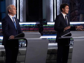 Conservative Leader Erin O'Toole listens to Liberal Leader Justin Trudeau speak during the federal election French-language leaders debate at the Canadian Museum of History in Gatineau, Quebec, Canada on Sept. 8, 2021.