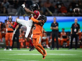 Ottawa Redblacks' Ryan Davis, left, fails to make the catch as B.C. Lions' T.J. Lee defends during the second half of a CFL football game in Vancouver, on Saturday, September 11, 2021.