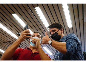 More of the same: Prime Minister Justin Trudeau poses for a photo as he greets commuters at a Montreal Metro station on Tuesday, Sept. 21, the morning after the federal election.