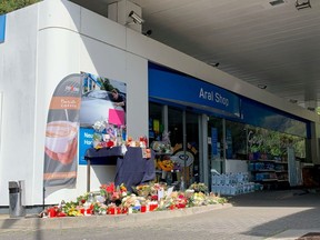 Flowers are placed in front of a gas station in Idar-Oberstein, Germany, September 21, 2021, after a 20-year-old gas station attendant who asked a customer to wear a face mask was shot dead last Saturday, September 18, 2021.