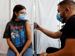 An Israeli woman receives a third shot of COVID-19 vaccine in Tel Aviv.