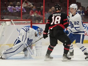 Toronto Maple Leafs goalie Petr Mrazek (35) covers the puck in front of Ottawa Senators left wing Tim Stuetzle (18) at the Canadian Tire Centre on Wednesday.