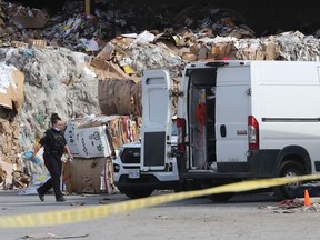 Ottawa police investigate the scene at a recycling business on Sheffield Road on Friday.