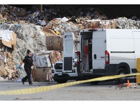 Ottawa police investigate the scene at a recycling business on Sheffield Road on Friday.