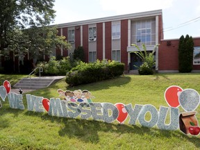 A sign welcomes students back to Holy Cross Elementary School in Ottawa.