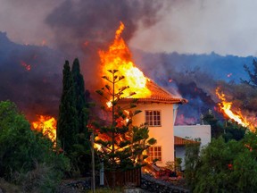 A house burns due to lava from the eruption of a volcano in the Cumbre Vieja national park at Los Llanos de Aridane, on the Canary Island of La Palma, September 20, 2021.