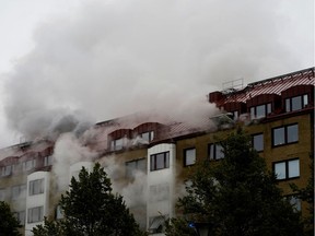 Smoke comes out of windows after an explosion hit an apartment building in Annedal, central Gothenburg, Sweden September 28, 2021.