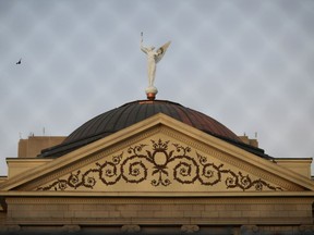 The Arizona state Capitol is pictured through a fence.