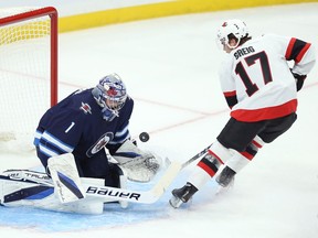 Winnipeg Jets goaltender Eric Comrie stops Ottawa Senators forward Ridly Greig from in close during NHL exhibition play at Canada Life Centre in Winnipeg on Sun., Sept. 26, 2021.