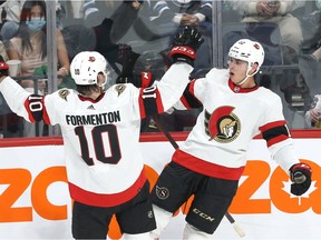 Ottawa Senators forward Alex Formenton (left) celebrates an overtime goal from Shane Pinto during NHL exhibition play at Canada Life Centre in Winnipeg on Sun., Sept. 26, 2021.