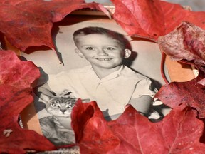 John never lost his boyish sense of humour, his love of animals or his distaste for being photographed. He's pictured here with fallen leaves from his maple tree.