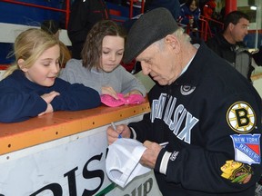 A file photo shows Hockey Hall of Famer Leo Boivin signing autographs in Prescott's community centre in March 2016. Boivin has died at the age of 89, it was announced Saturday.

File photo/Postmedia