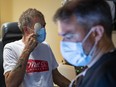 Optometrist Dr. Joshua Smith examines 57-year-old Denis Sauve at the vision care pilot program at
the Wabano Centre for Aboriginal Health.