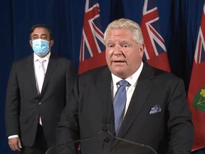 Premier Doug Ford announces plans for reopening the economy lat week. Kaleed Rasheed, left, the associate minister of digital government, was among the officials present.