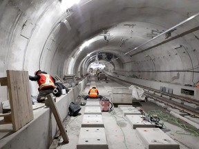 Workers install rail tracks through the Confederation Line LRT tunnel in a picture dated Feb. 16, 2018. Source: City of Ottawa