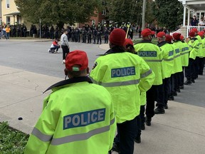 Large numbers of police officers block access to Earl Street and Aberdeen Street in Kingston on Saturday.