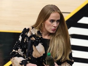Files: Singer Adele walks a NBA Finals game in July, 2021.