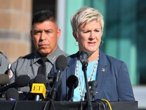 Santa Fe County Sheriff Adan Mendoza (L) looks on as First Judicial District Attorney Mary Carmack-Altwies for the state of New Mexico speaks during a press conference at the Santa Fe County Public Safety Building to update members of the media on the shooting accident on the set of the movie "Rust" at the on October 27, 2021 in Santa Fe, New Mexico.
