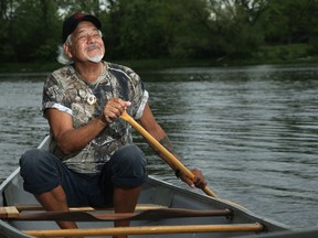 Algonquin storyteller and spiritual guide Albert Dumont basks in the healing surroundings of the Rideau River as he paddles from Dutchie's Hole Park canoe launch in late July.