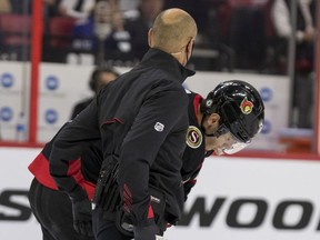 Senators centre Shane Pinto (12) is helped off the ice during the first period of Thursday's game against the Sharks with what initially appeared to be a shoulder injury. He returned for one shift in the second period, but did not play again after that.