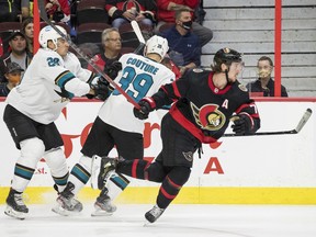 Ottawa Senators defenceman Thomas Chabot (72) avoids the check of San Jose Sharks right wing Timo Meier (28) and San Jose Sharks centre Logan Couture (39) during second period NHL action at the Canadian Tire Centre on Thursday.