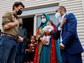 Canada's Prime Minister Justin Trudeau greets the Rahimi family (Ayat, Arezoo, Hawa, Obaidullah) who recently resettled in Ottawa from Afghanistan, in Ottawa, Canada, October 9, 2021.