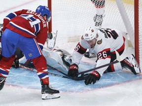 Ottawa Senators' Erik Brannstrom gives goaltender Anton Forsberg a helping hand to stop Montreal Canadiens' Brendan Gallagher during second period preseason NHL hockey action in Montreal on Saturday, October 2, 2021.