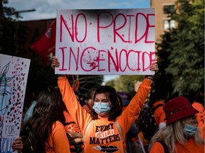 A woman holds up a placard during the "Every Child Matters" march to mark the first National Day for Truth and Reconciliation in Montreal on Sept. 30.