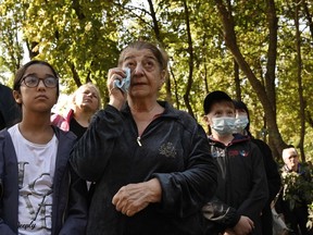 A woman wipes way tears as she and others gather at the ravine near Kiev to mark the 80th anniversary of the Babi Yar massacre, one of the largest mass slaughters of Jews during the Second World War.