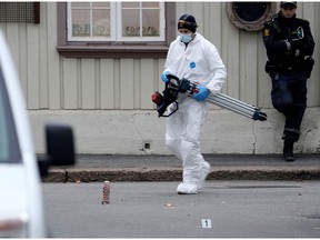 TOPSHOT - A police forensic carries material during investigations after a man armed with a bow and arrows killed 5 people before being arrested by police in Kongsberg, on October 14, 2021.