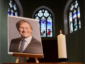A candle and a portrait of British MP David Amess, who was stabbed to death during a meeting with constituents, are seen at the church of St Michael's and all Angels, in Leigh-on-Sea, Britain, October 17, 2021.