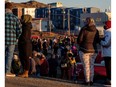 Hundreds of residents line up to collect bottled water after city officials in the northern territory said lab results confirmed that fuel had entered its water supply in Iqaluit, Nunavut, October 15, 2021.
