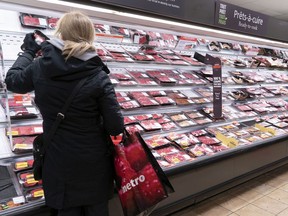 A customer shops at a meat counter in a grocery store in Montreal, in this file photo. More and more, consumers are being given an opportunity to “rescue” food from an almost certain fate in a landfill.