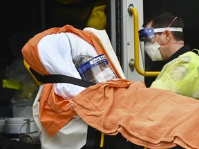Paramedics take away an elderly patient at the Tendercare Living Centre, long-term-care facility during the COVID-19 pandemic in Scarborough, Ont., on Wednesday, December 23, 2020. Nearly half of its 254 residents along with 47 staff members so far have tested positive for the coronavirus.