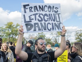 People take part in a protest in support of a return to dancing in venues in Montreal, Saturday, Oct. 23, 2021. Quebec and British Columbia are the only two provinces that continue to ban dancing in bars and nightclubs as part of their COVID-19 regulations.