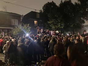 Students gather in Russell Avenue for a post-Panda party, Oct. 2, 2021 in this photo taken by a resident. Some students are standing on top of a car.