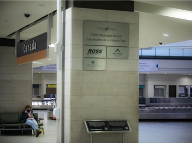 A woman sits and waits at the Ottawa International Airport on Sunday, Oct. 31, 2021.