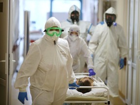 Medical specialists wearing protective gear transport a patient at the City Clinical Hospital Number 1, where people suffering from the coronavirus disease (COVID-19) are treated, in Volzhsky, Russia October 25, 2021.