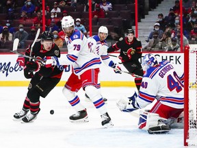 Ottawa Senators left wing Brady Tkachuk (7) battles it out in front of the Rangers' net with New York Rangers defenceman K'Andre Miller (79) during second period NHL action in Ottawa on Saturday, Oct. 23, 2021.