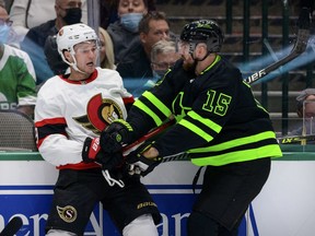 Ottawa Senators center Josh Norris (9) gets checked by Dallas Stars left wing Blake Comeau (15) during the second period at the American Airlines Center.