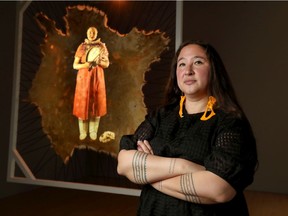 Artist Laakkuluk Williamson Bathory in front of her art.