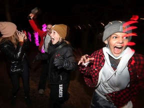 Colin Samojlenko from Saunders Farm scares and chases Marlowe Saunders, Leah Clark and Victoria Rasa Thursday night as part of the farm's Halloween festivities.