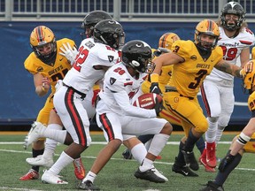 Denny Ferdinand of the Carleton Ravens looks for an opening against the Queen's Gaels in Ontario University Athletics football action at Richardson Stadium in Kingston on Saturday  October 16, 2021.