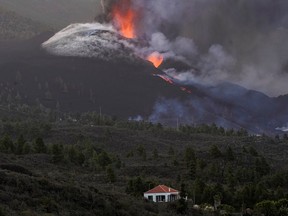 FILE PHOTO: The Cumbre Vieja volcano continues to erupt on the Canary Island of La Palma, as seen from Tacande de Arriba, Spain, October 2, 2021.
