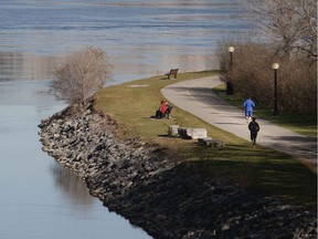 Files: Walkers enjoy the weather along the Ottawa River path behind Parliament Hill