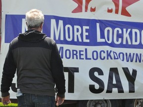 MPP Randy Hillier looks on as a truck pulling an anti-lockdown sign makes its way to the protest in Cornwall on May 1.