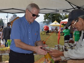Stormont-Dundas-South Glengarry MPP Jim McDonell buying some local goodies at the Iroquois Apple Festival on Saturday September 18, 2021 in Cornwall, Ont.